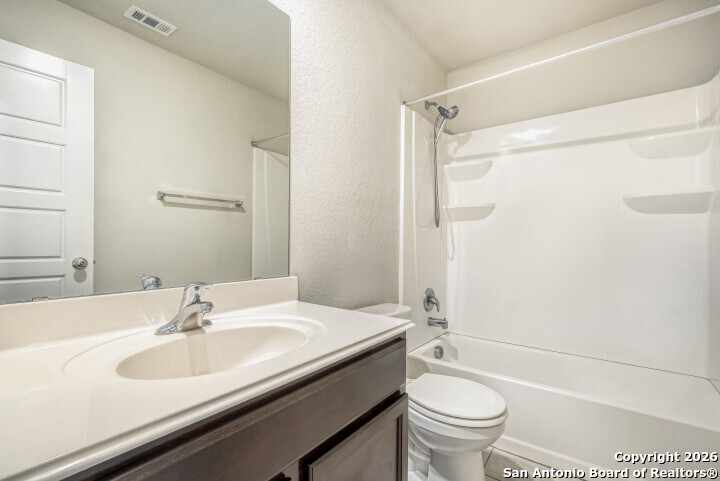 10583 Penelope Way Converse, TX 78109 - Photo 23 of 26 a bathroom with a sink a toilet and a mirror