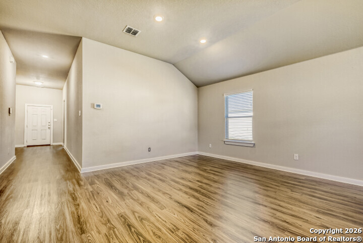 10583 Penelope Way Converse, TX 78109 - Photo 6 of 26 wooden floor in an empty room with a window