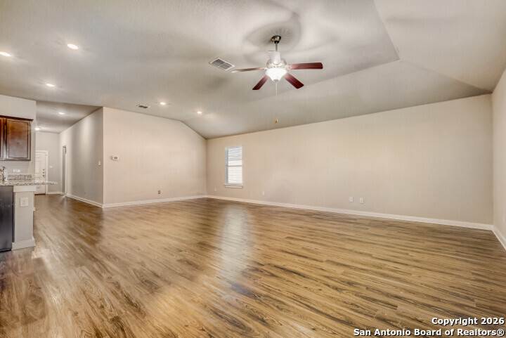 10583 Penelope Way Converse, TX 78109 - Photo 7 of 26 an empty room with wooden floor and windows