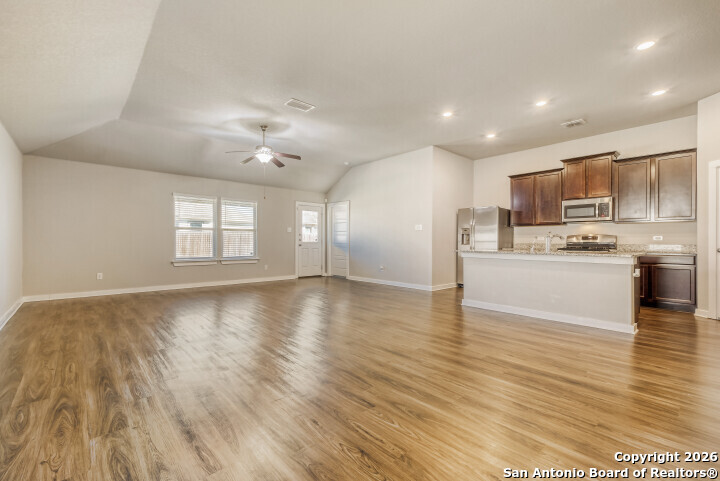 10583 Penelope Way Converse, TX 78109 - Photo 9 of 26 a view of a kitchen with a stove cabinets and wooden floor