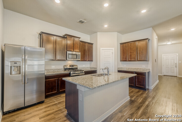 10583 Penelope Way Converse, TX 78109 - Photo 10 of 26 a kitchen with stainless steel appliances granite countertop a sink stove and refrigerator