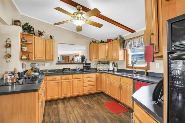 a kitchen with stainless steel appliances granite countertop a sink a stove and a refrigerator