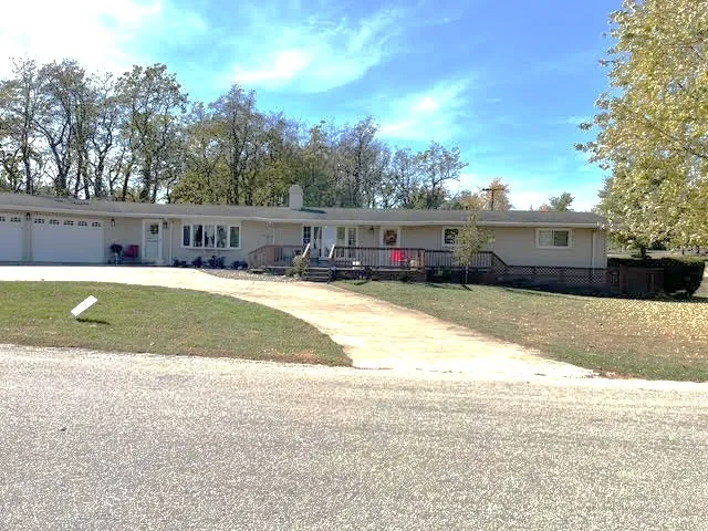 a view of a house with swimming pool and a yard