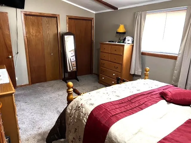 a bedroom with a bed and cabinets