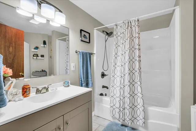 a bedroom with furniture and a mirror