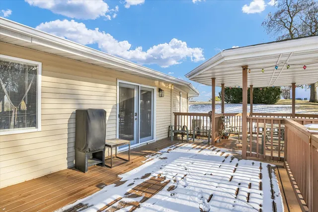 a view of a patio with a table chairs and wooden floor