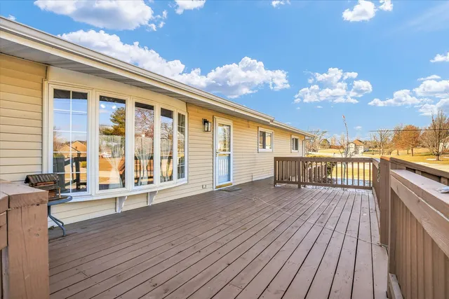 a view of a house with wooden deck