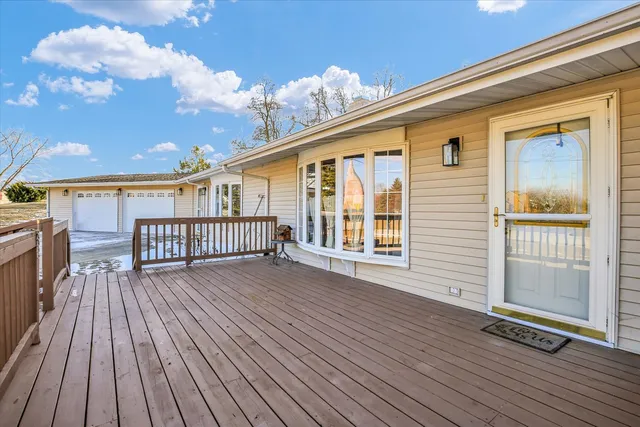 a dining room with furniture a chandelier and wooden floor