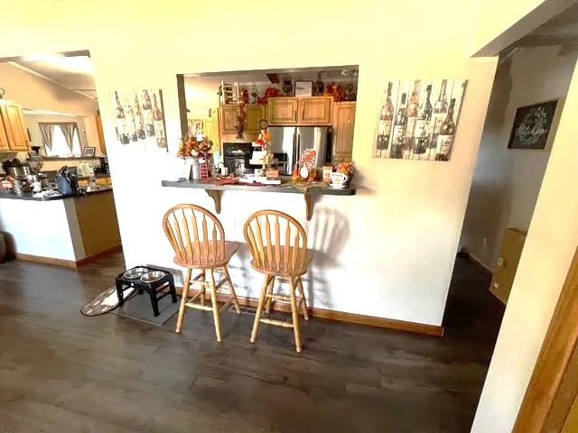 a view of a dining room with furniture and a floor to ceiling window