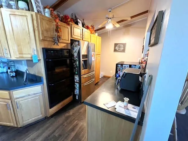 a kitchen with granite countertop a refrigerator and a stove top oven