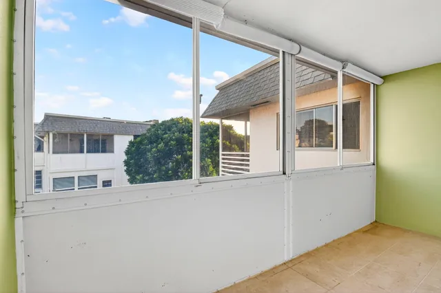 a view of a room that has a bed and a window