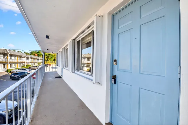 a front view of a house with parking space