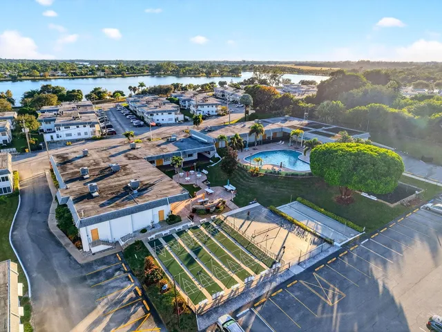 an aerial view of a house with a swimming pool yard and outdoor seating