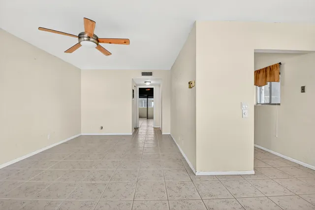 a view of a livingroom with a ceiling fan and entryway
