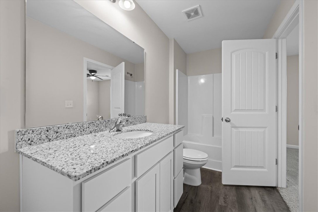 115 Adger Road Pendleton, SC 29670 - Photo 23 of 36 Granite counters and rich wood-tone flooring complete this well-appointed bathroom.