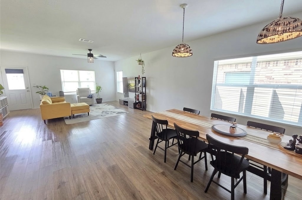 208 Wolf Springs Road Georgetown, TX 78628 - Photo 6 of 32 Natural light illuminates rich hardwood flooring throughout this inviting open-concept living space.