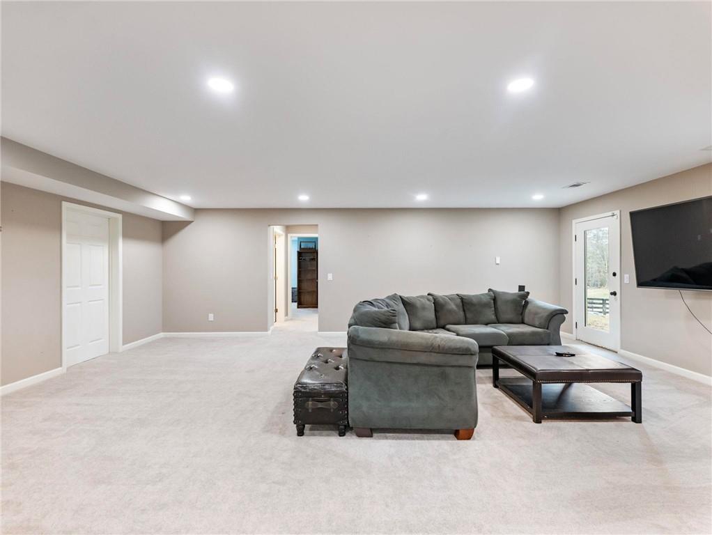 8629 Drake Drive Lula, GA 30554 - Photo 40 of 78 a living room with furniture and a flat screen tv
