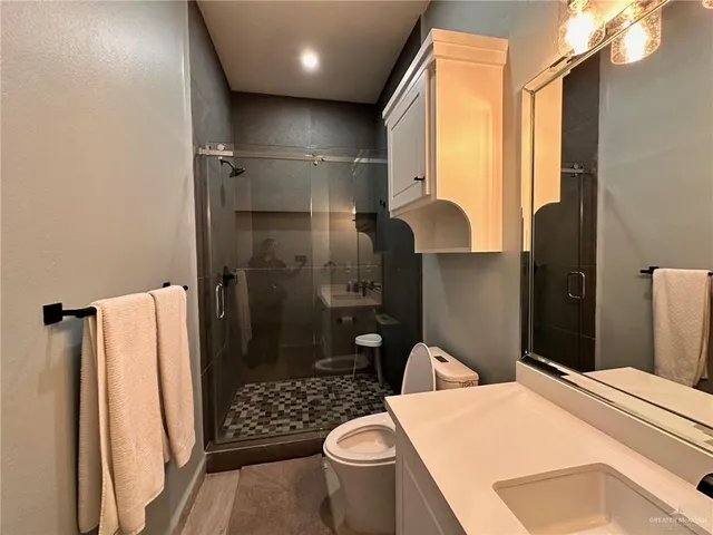 a bathroom with a sink toilet and shower