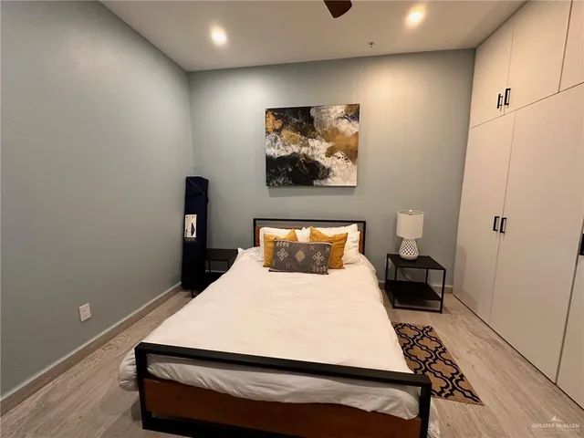 a bed sitting in a bedroom next to a bathroom