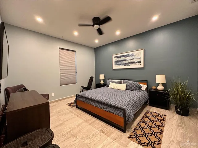 a bedroom with a bed and a ceiling fan