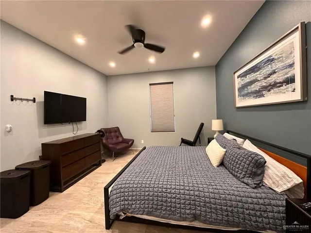 a bedroom with a bed and a flat screen television