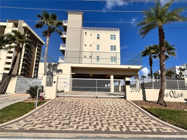 a front view of a building with a garden