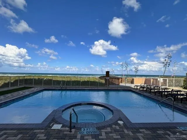 a view of a balcony with dining table & chairs