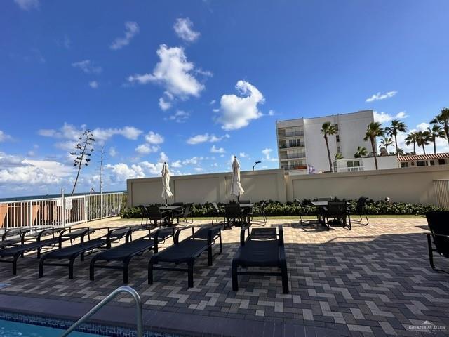 2700 Gulf Boulevard, Unit 204 South Padre Island, TX 78597 - Photo 27 of 31 a roof deck with table and chairs