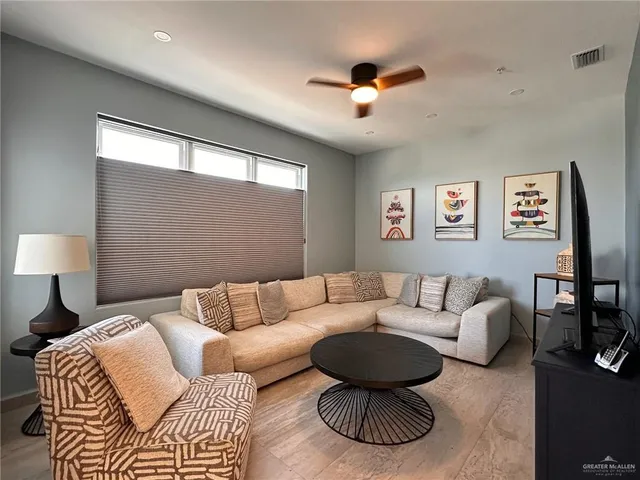 a living room with furniture and a large window