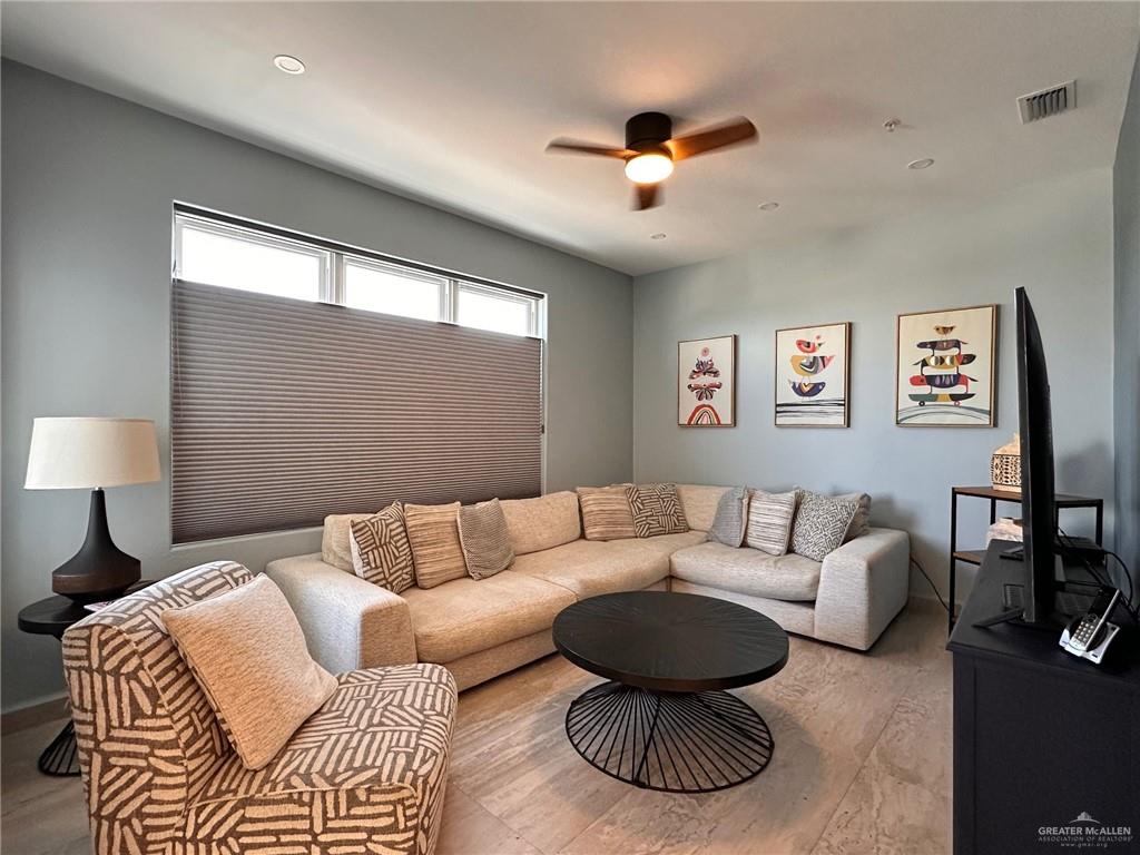 2700 Gulf Boulevard, Unit 204 South Padre Island, TX 78597 - Photo 5 of 31 a living room with furniture and a large window