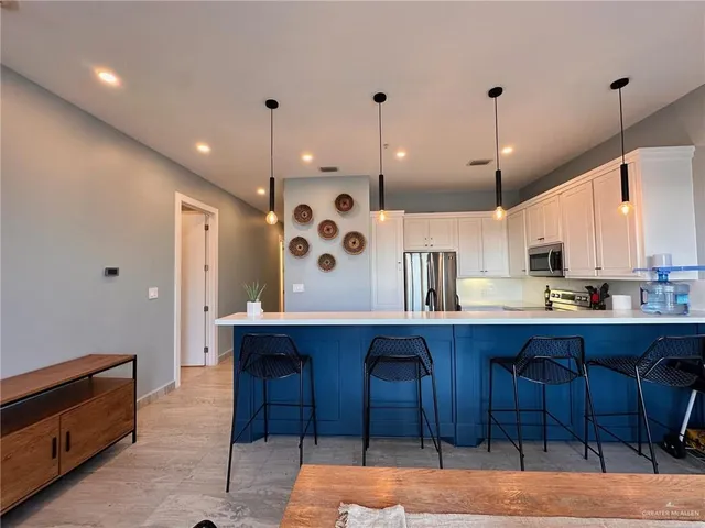 a large kitchen with a table and chairs