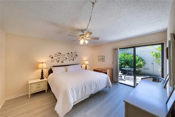 a bedroom with a bed and a large window