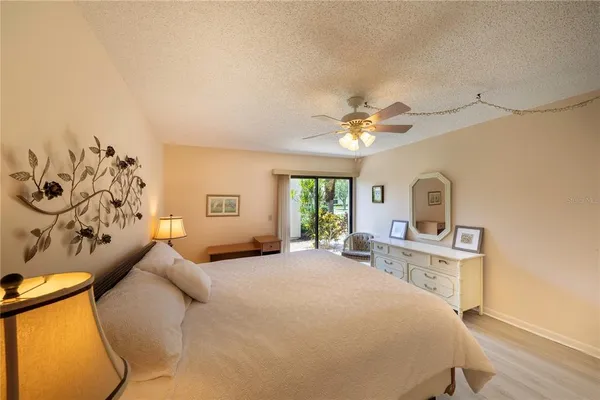 a bedroom with a bed dresser and a window