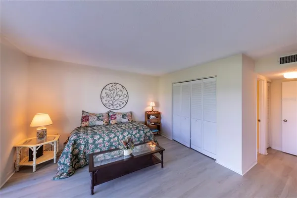 a bedroom with a bed and a lamp on table