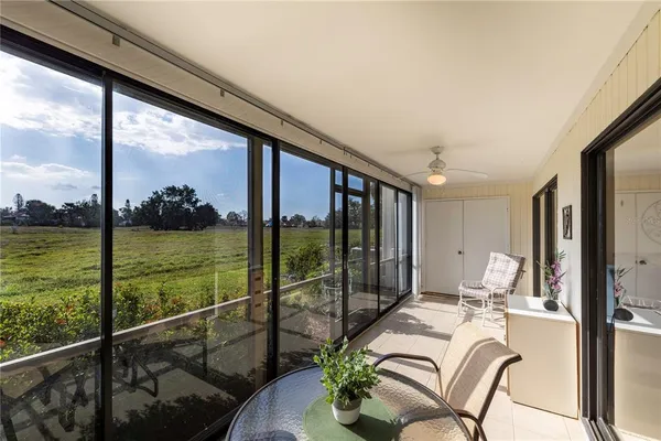 a dining room with furniture and floor to ceiling window