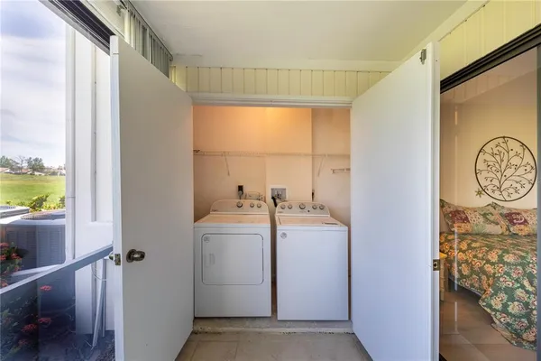 a view of storage and utility room with a window