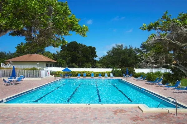a view of a backyard with swimming pool