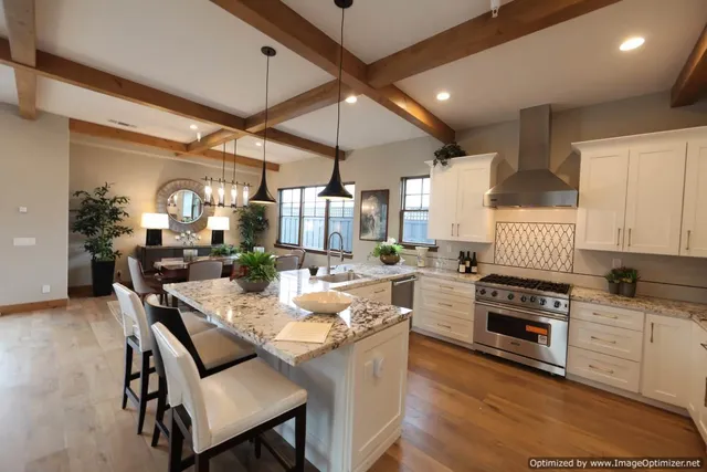 a kitchen with a table chairs stove and cabinets