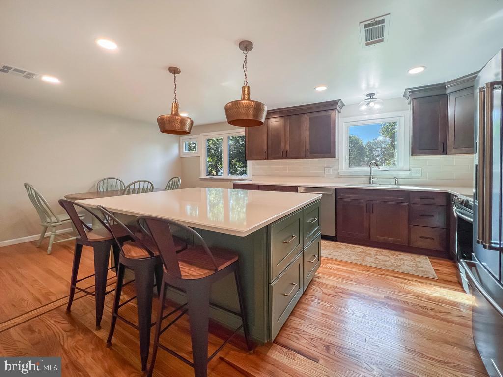 4643 Lerch Road Bensalem, PA 19020 - Photo 13 of 69 a kitchen with stainless steel appliances granite countertop wooden floor sink and cabinets