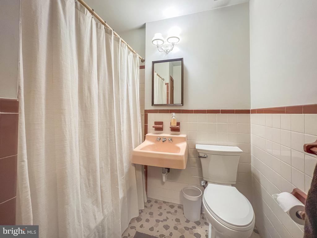 4643 Lerch Road Bensalem, PA 19020 - Photo 29 of 69 a bathroom with a toilet a sink and a mirror