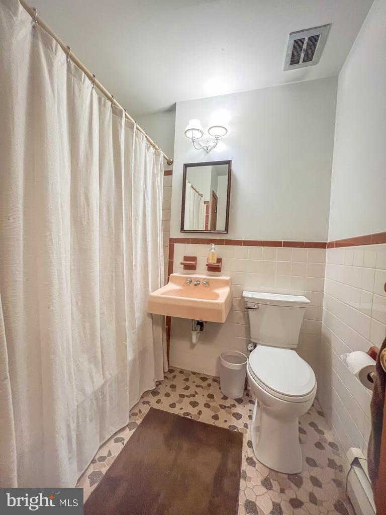4643 Lerch Road Bensalem, PA 19020 - Photo 30 of 69 a bathroom with a sink toilet and shower
