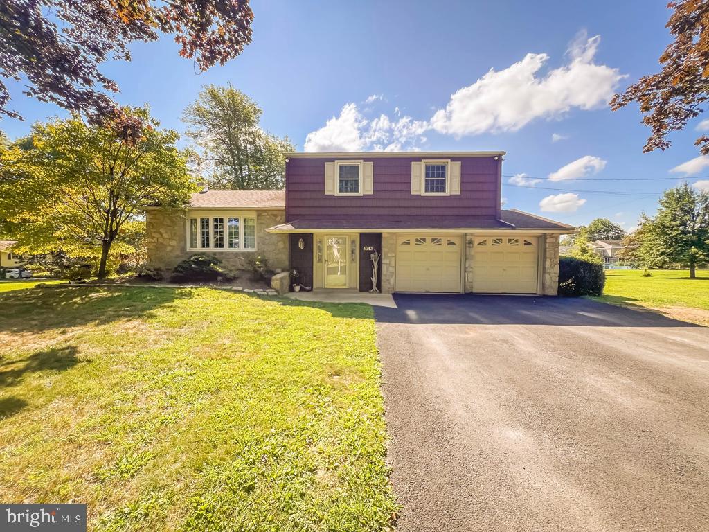 4643 Lerch Road Bensalem, PA 19020 - Photo 49 of 69 a front view of a house with a yard and garage