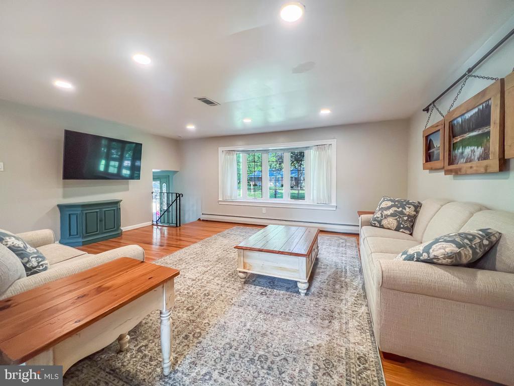 4643 Lerch Road Bensalem, PA 19020 - Photo 64 of 69 a living room with furniture a flat screen tv and a fireplace