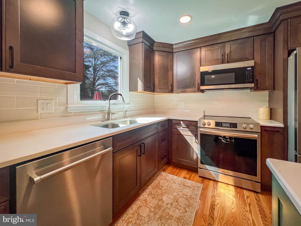 4643 Lerch Road Bensalem, PA 19020 - Photo 10 of 69 a kitchen with stainless steel appliances a sink stove and microwave