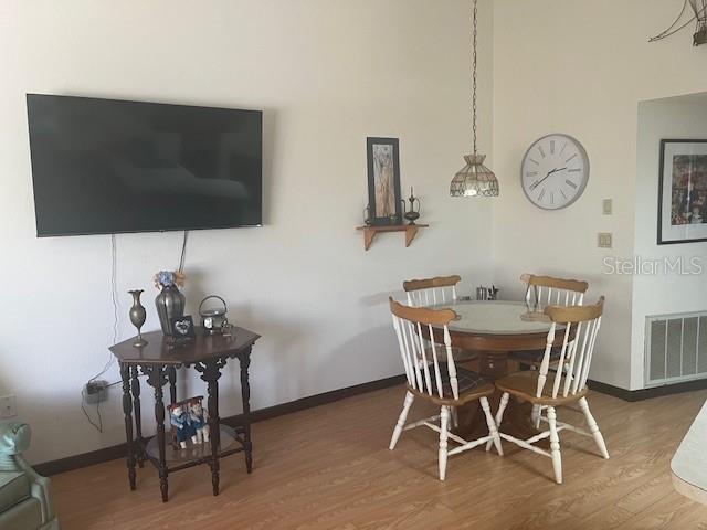 9030 Hernando Way Weeki Wachee, FL 34613 - Photo 13 of 40 a view of a dining room with furniture and wooden floor
