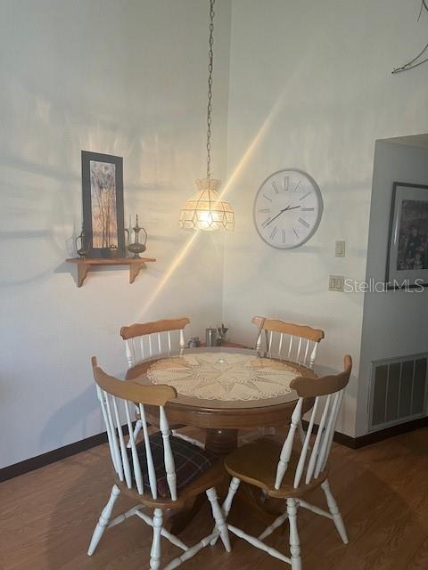 9030 Hernando Way Weeki Wachee, FL 34613 - Photo 14 of 40 a view of a dining room and livingroom with furniture wooden floor and a chandelier