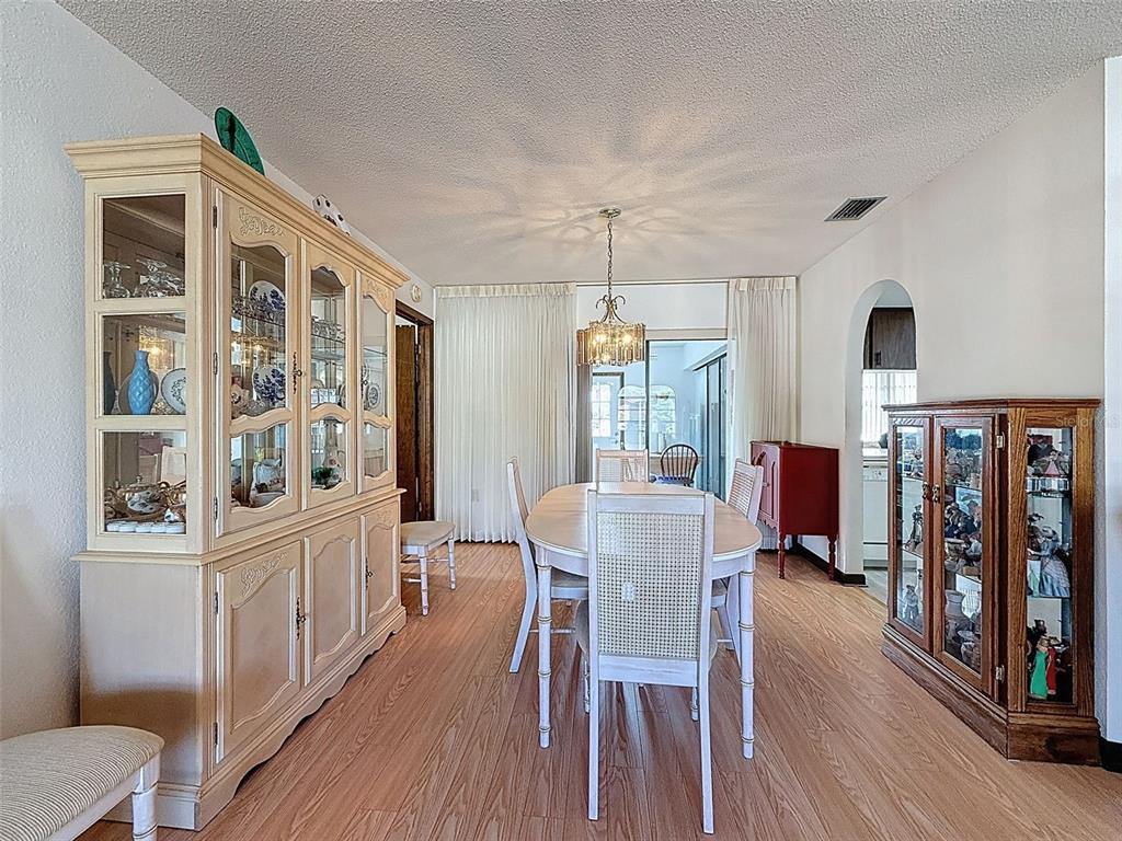 9030 Hernando Way Weeki Wachee, FL 34613 - Photo 15 of 67 a view of a dining room with furniture window and wooden floor
