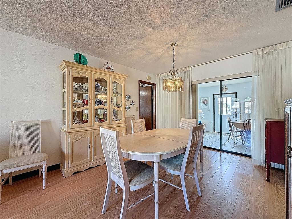 9030 Hernando Way Weeki Wachee, FL 34613 - Photo 16 of 67 a view of a dining room with furniture window and wooden floor
