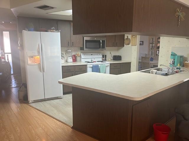 9030 Hernando Way Weeki Wachee, FL 34613 - Photo 16 of 40 a kitchen with stainless steel appliances a refrigerator and a stove top oven