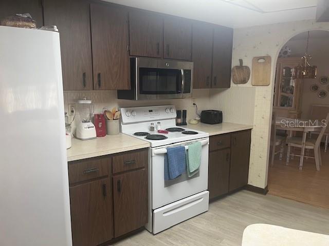 9030 Hernando Way Weeki Wachee, FL 34613 - Photo 17 of 40 a kitchen with a sink a stove and cabinets